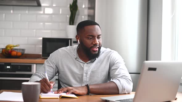 An African American Guy is Using Laptop for Work