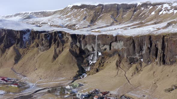 Small and Beautiful Waterfall on a Snowcapped Ledge in the Winter