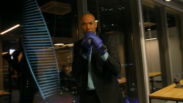 Ready To Business Fight Concept. African Boxer in Gloves and Formal Suit Waving with His Boxing