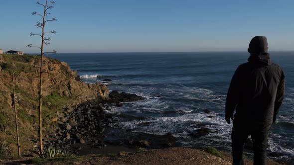 man looking at the sea in pichilemu punta de lobos chile, amazing surf spot