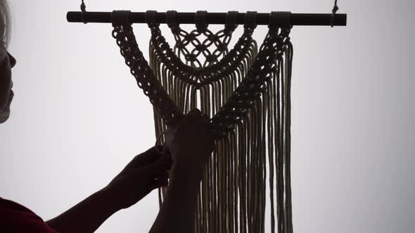 Woman Craftsman Weaves Macrame From Light Cotton Threads