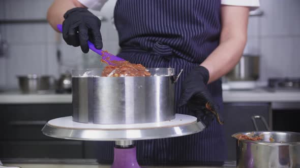 Confectionery  Putting Caramel with Peanuts on the Cake Base