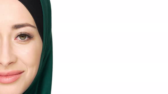 Halfside Portrait of Gorgeous Muslim Woman in Headscarf Posing on Camera with Charming Look and