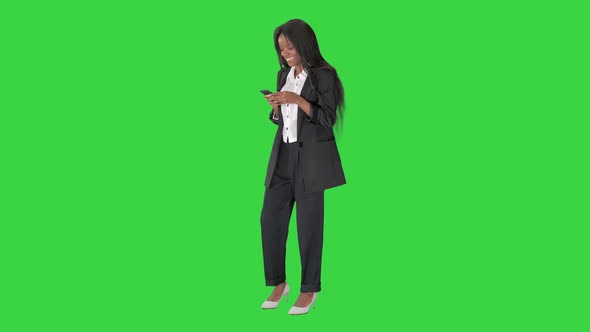 Happy African American Young Business Woman Holding Using Smart Phone Social Media Apps and Laughing