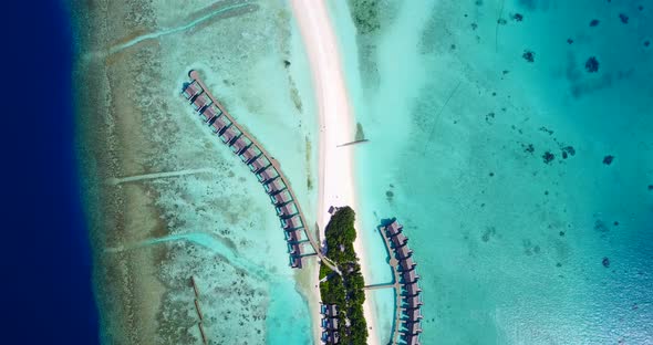 Tropical overhead abstract view of a white paradise beach and aqua blue ocean background in high res