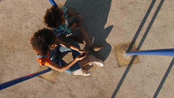 Mother and son using phone at playground