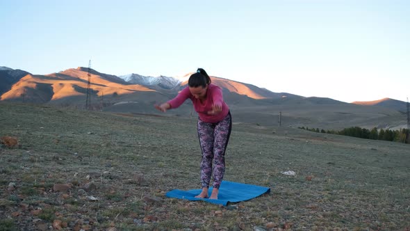 Female Doing Yoga Exercise in Mountains Landscape