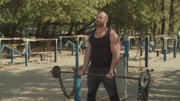 Athlete Performing Biceps Curls with Barbell