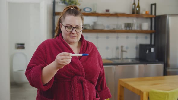 Obese Woman Walking Out of Bathroom with Pregnancy Test Feeling Frustrated Seeing Negative Result