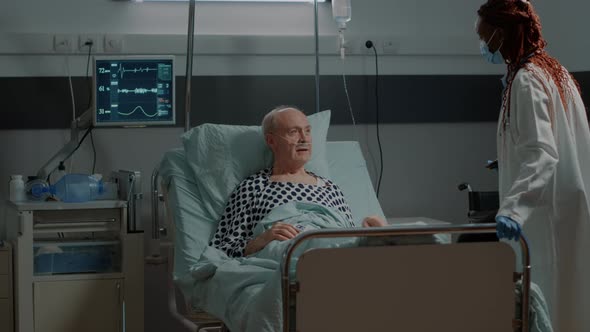 African American Medic Fixing Adjustable Bed for Patient