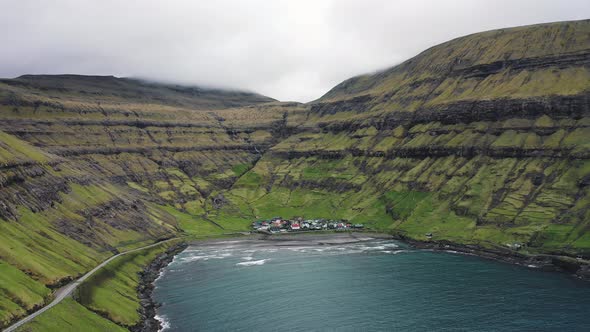 Flight Over a Bay Towards the Small Village of Tjornuvik on Faroe Islands
