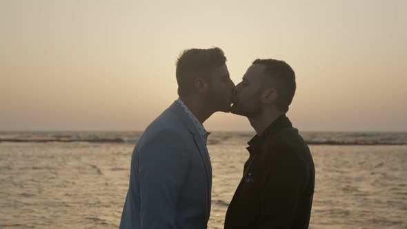 Gay couple together on the beach during sunset