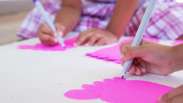 Kid hands using the colored felt pens on paper