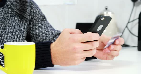 Young man shopping online on mobile phone