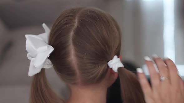 Mother Make Hairstyle for Her Daughter