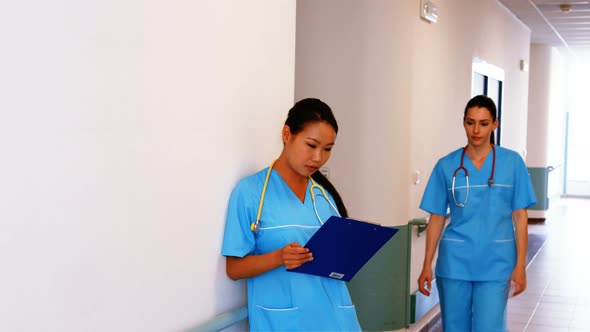 Nurses looking at clipboard