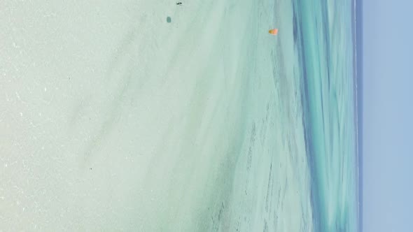 Vertical Video Kitesurfing Near the Shore of Zanzibar Tanzania Aerial View