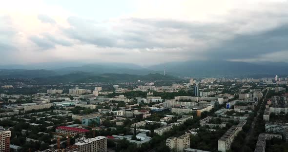 Top View of Almaty City. Green Streets, Big Clouds