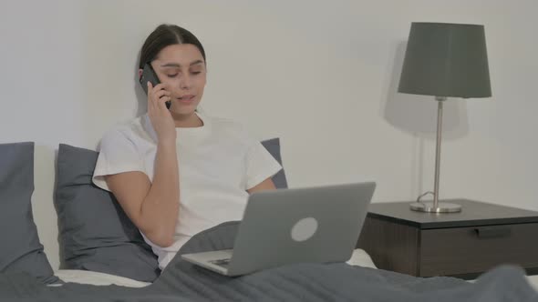 Indian Woman Celebrating Success on Tablet in Office