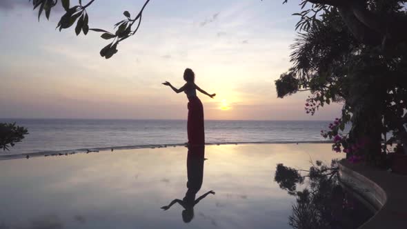 Lonely Elegance Woman Dancing in the Romantic Evening Near Water Sunset and Female Sihoulette