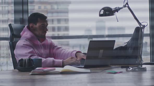 A Young Handsome Man Works in an Office Space