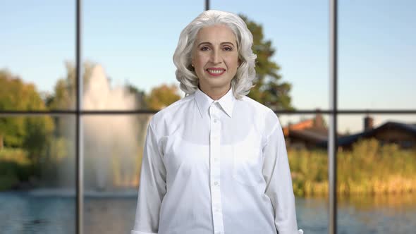 Smiling Mature Businesswoman Looking at Camera.