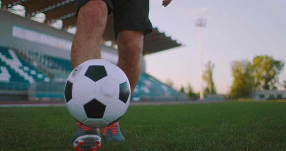 Tilt Up with Slow Motion of Male From Professional Soccer League Juggling Ball on Leg in Outdoor