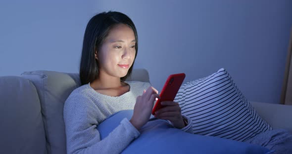 Woman read on smart phone in city at night
