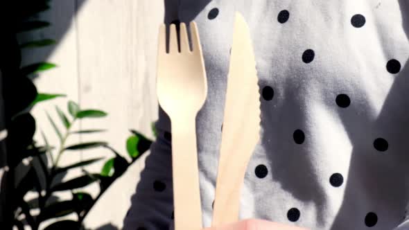 Slow Motion Female Hands Holding Wooden Forks and Paper Cups with Plates