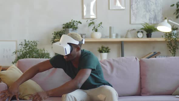 Black Man Enjoying Augmented Reality with VR Glasses and Home