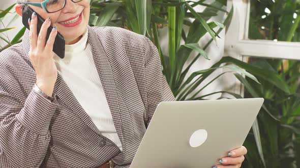 Modern Senior Businesswoman Talking on Mobile Phone