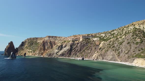 Aerial View From Above on Calm Azure Sea and Volcanic Rocky Shores