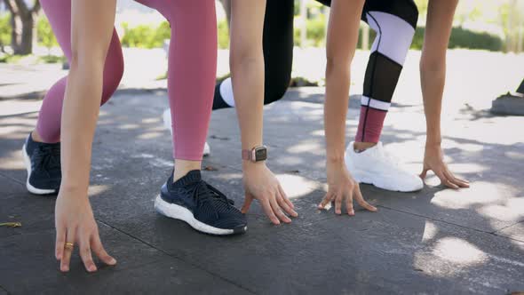 Two Women Preparing for Run in Park