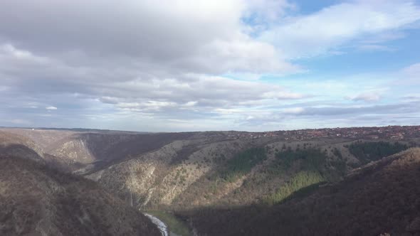 Cloudy sky over curvy flow of river Timok 4K aerial video