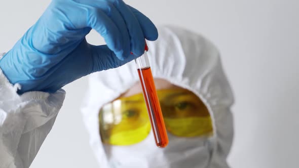 A Doctor in a Protective Suit Conducts a Blood Test of a Patient with a New Coronavirus 2019nCoV
