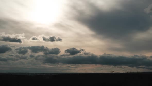 Clouds in the Sky Move Against the Background of the Sun at Sunset Timelapse