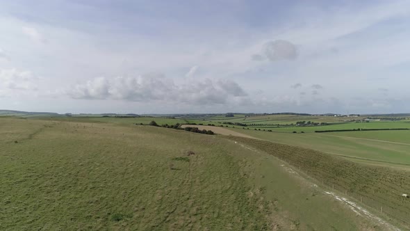 Aerial tracking upwards from maiden castle to reveal the northern ramparts and the vast Dorset count