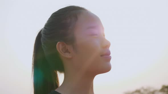 Young woman in sportswear looks at camera and smile.