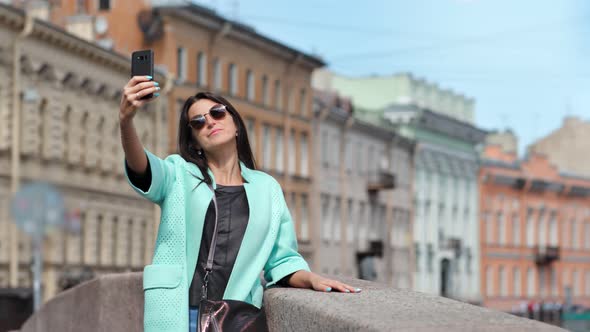 Positive Attractive Travel Female Taking Selfie Using Smartphone at Historical Building Background