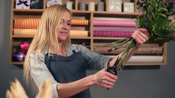 Slowmotion Shot of Professional Female Floral Artist Preparing a Bouquet Florist Cutting Flower