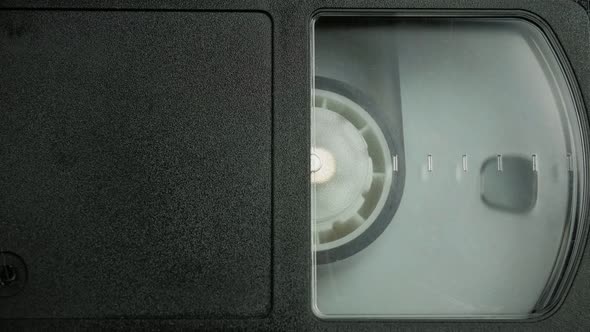 The Right Side of the VHS Cassette. a Film Reel Spins