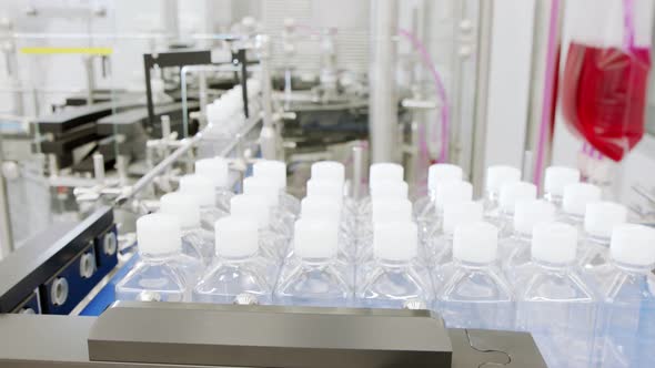 Automated pharmaceutical manufacturing line, bottles filled with liquid