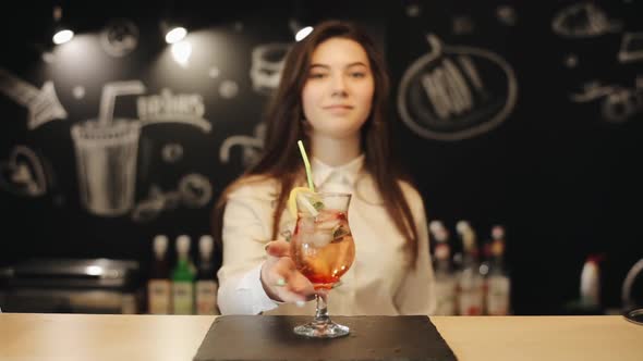 A Beautiful Female with an Attractive Smile Enjoying Mojito at a Bar Counter