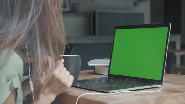 Person Using Laptop with Green Screen