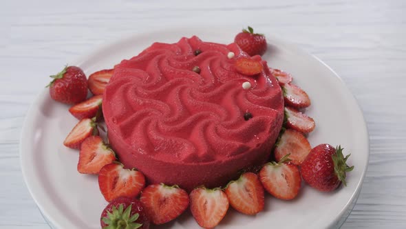 Pink Strawberry Cake Spins on a White Plate