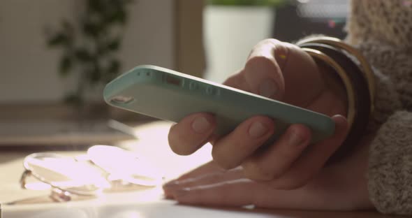 Young Woman Scrolling her Smartphone