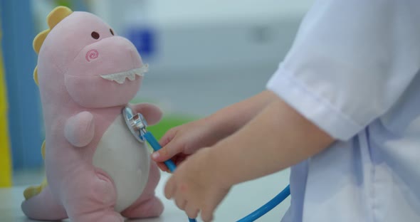 Cute Preschool Boy Kid Wearing White Medical Uniformlistening to Pets Breathingparrots and Toy