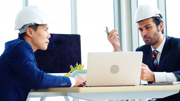 Engineer and Architect Meeting at Office Table