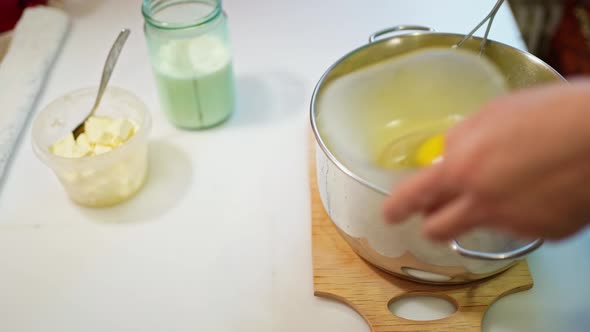 Female Hands Prepare Mashed Potatoes Knead the Potatoes in a Saucepan with a Crush and Add a Raw Egg