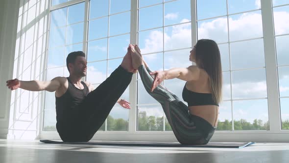 Wellness Man and Woman Do Yoga Together Perform Stands and Muscle Stretching Joint Training of a